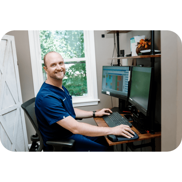Dentist at desk with computer